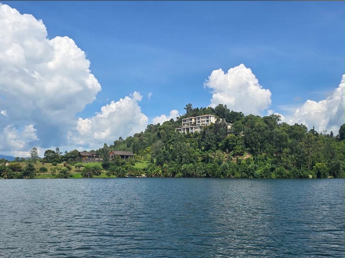 Deep blue waters of Lake Kivu fringed by wooded green shoreline in Rwanda