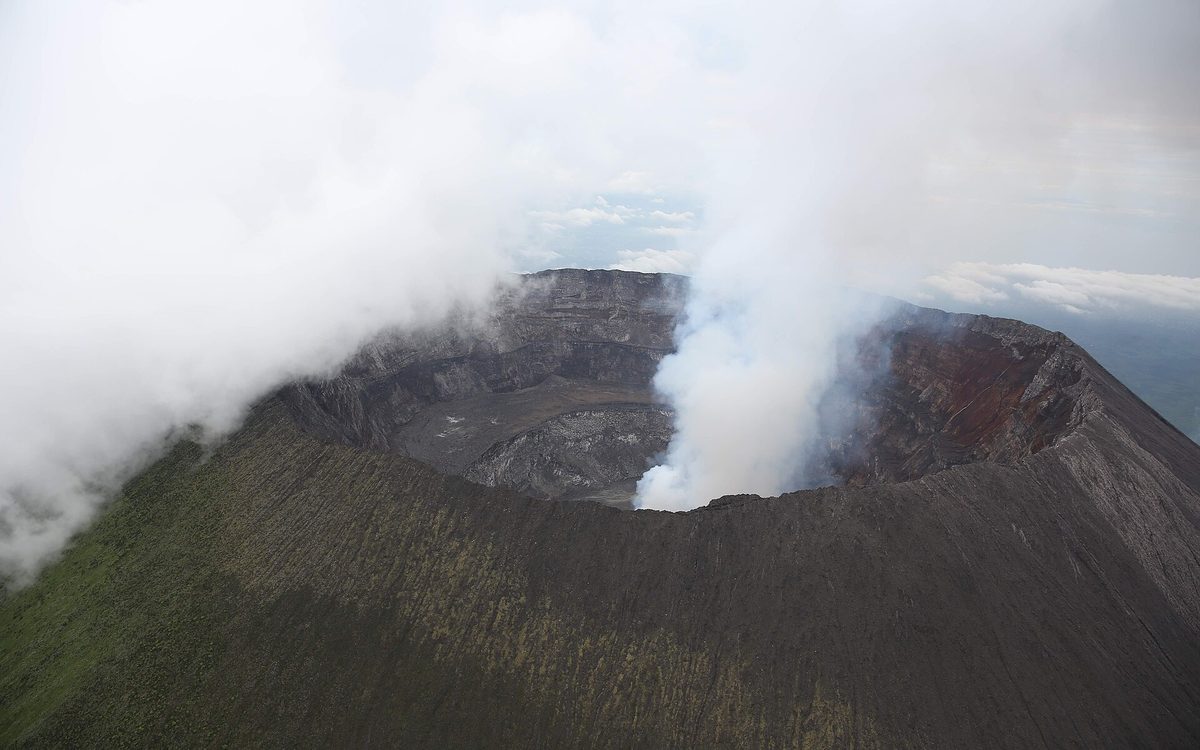 Steam rising from the rim of the Nyiragongo volcano crater