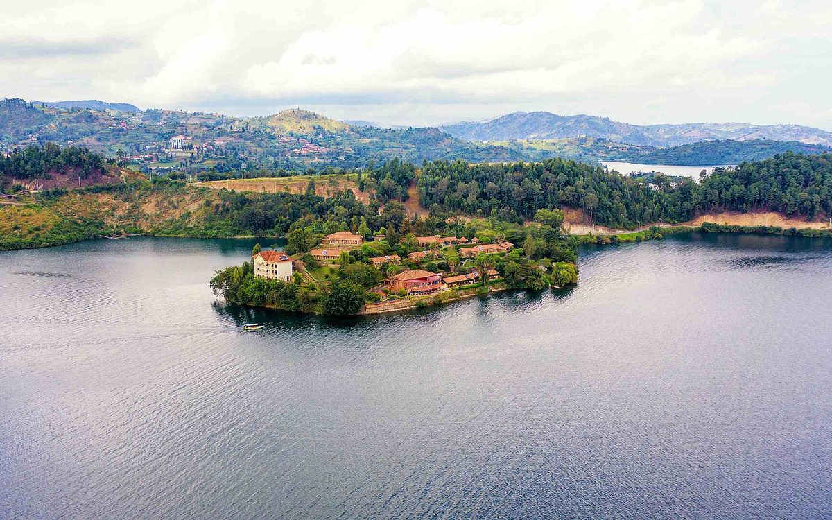 Lakeside resort on a green peninsula surrounded by the calm water of Lake Kivu